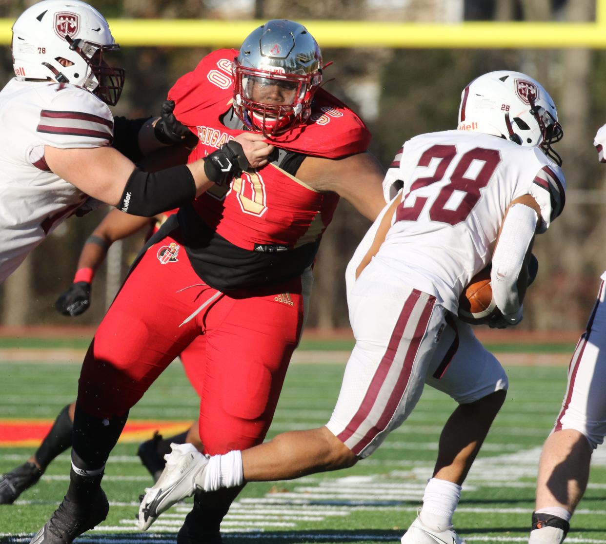 Sydir Mitchell of Bergen Catholic sheds a block to tackle Ronnie Heath of Don Bosco during a 2020 game. The 2023 four-star defensive tackle has committed to Texas.