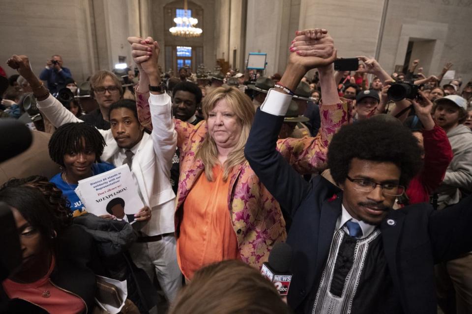 Former Rep. Justin Jones, D-Nashville, Rep. Gloria Johnson, D-Knoxville, and former Rep. Justin Pearson, D-Memphis, raise their hands outside the House chamber after Jones and Pearson were expelled from the legislature Thursday, April 6, 2023, in Nashville, Tennessee. (AP Photo/George Walker IV)