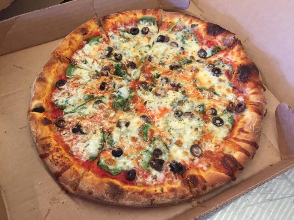 The Homesteader pizza - red sauce, baby spinach, Kalamata olives, herbed feta and preserved lemon - shown April 13, 2021 at Stone's Throw in Charlotte.