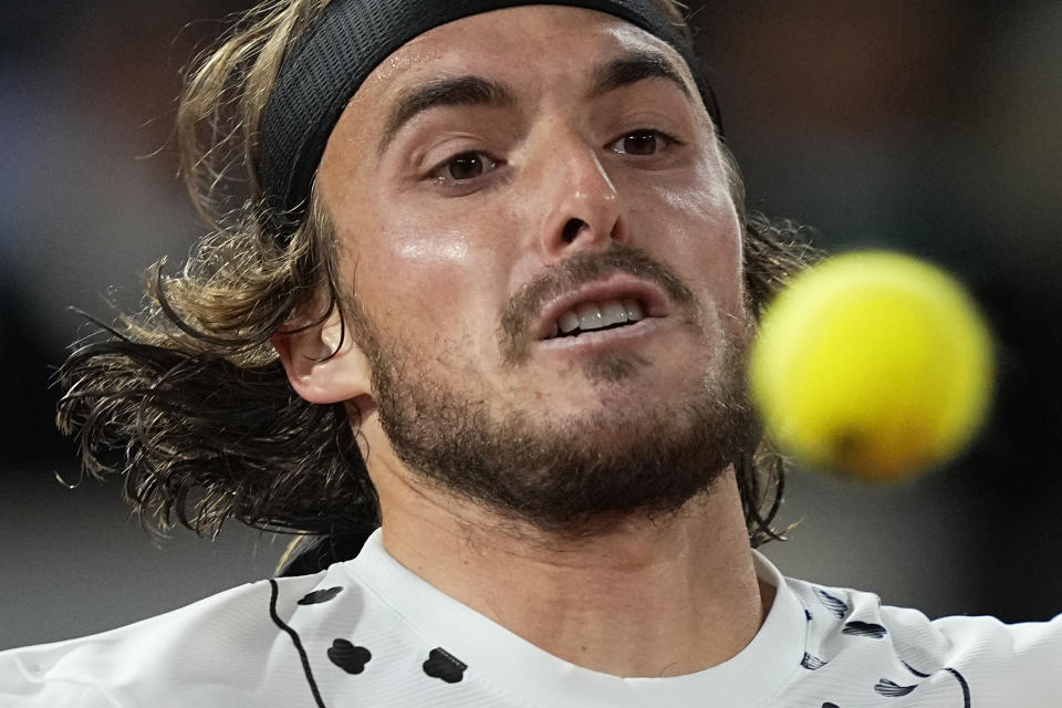 Greece's Stefanos Tsitsipas eyes the ball as he plays Italy's Lorenzo Musetti during their first round match of the French Open tennis tournament at the Roland Garros stadium Tuesday, May 24, 2022 in Paris. (AP Photo/Michel Euler)