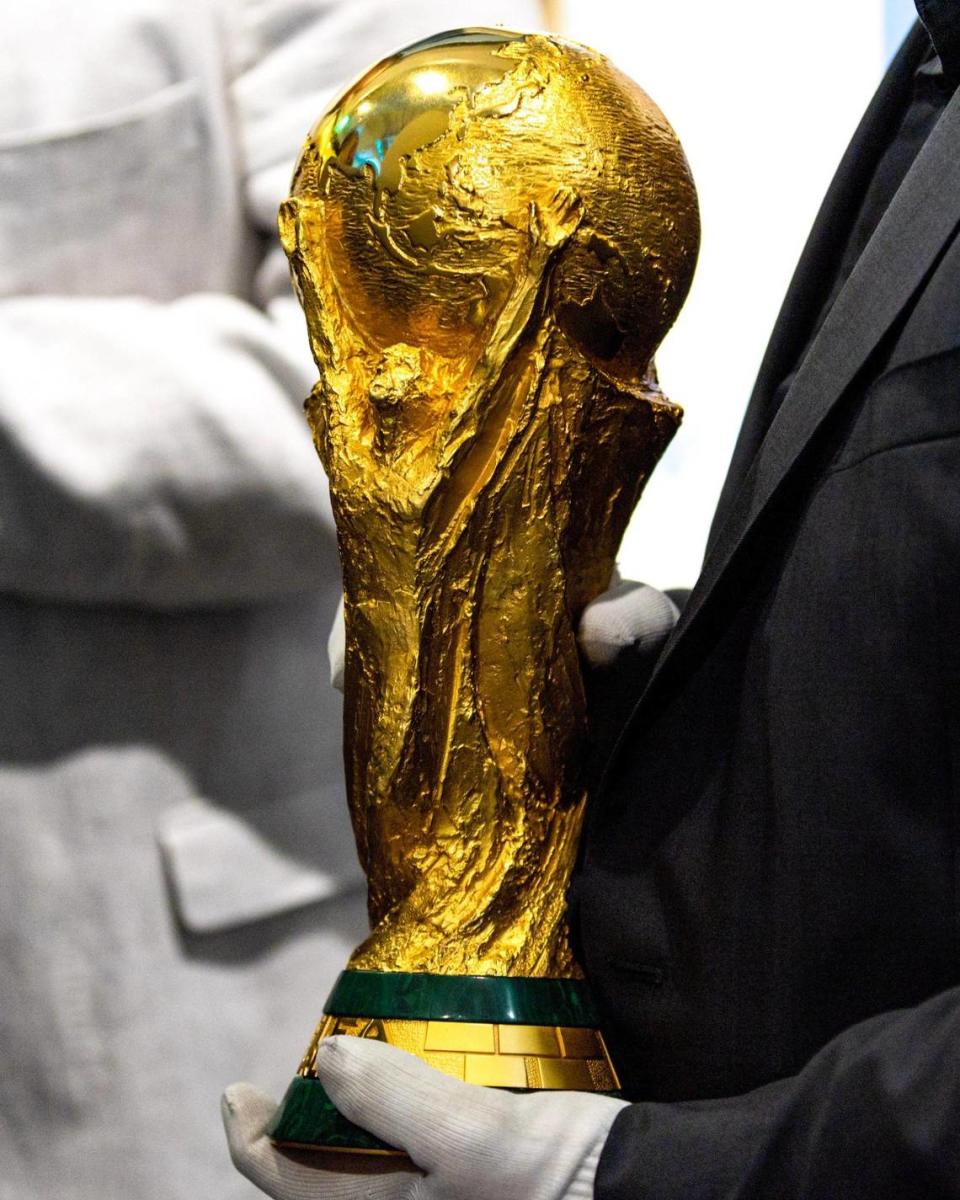 The FIFA World Cup trophy is handled during the unveiling of the new AFA offices in the Wynwood neighborhood of Miami, Florida, on Thursday, December 7, 2023.