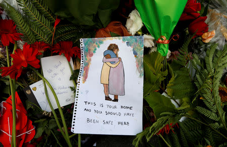 Flowers and signs are pictured at a memorial as a tribute to victims of the mosque attacks, near a police line outside Masjid Al Noor in Christchurch, New Zealand, March 17, 2019. REUTERS/Jorge Silva