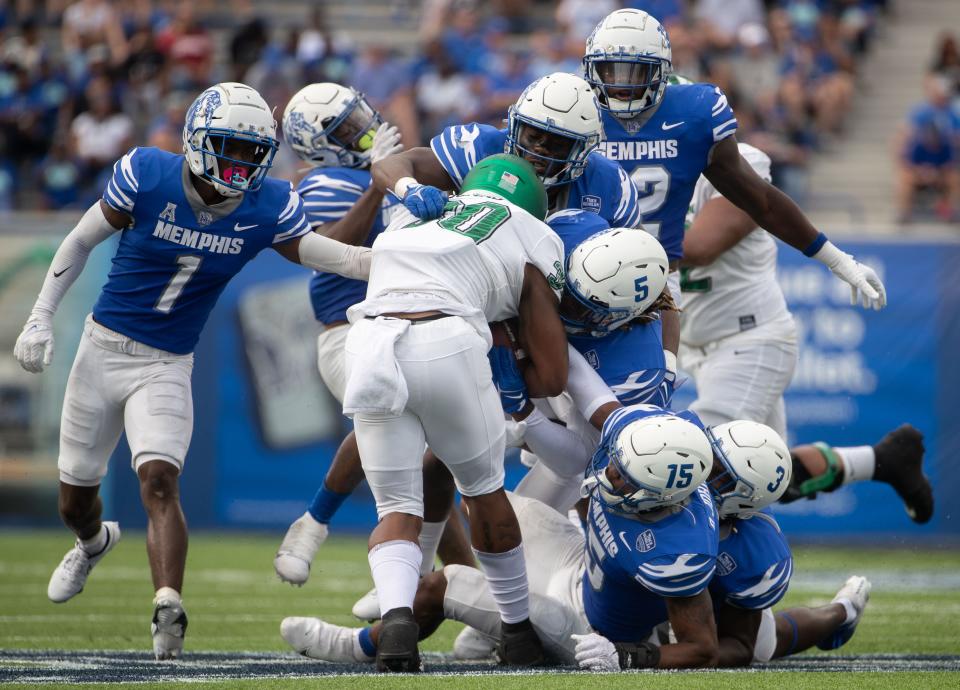 Memphis Tigers defense players block North Texas Mean Green tight end Var'Keyes Gumms (30) from advancing during the first half of a Memphis Tigers game against the North Texas Mean Green on Saturday, Sept. 24, 2022, at Simmons Bank Liberty Stadium in Memphis. 