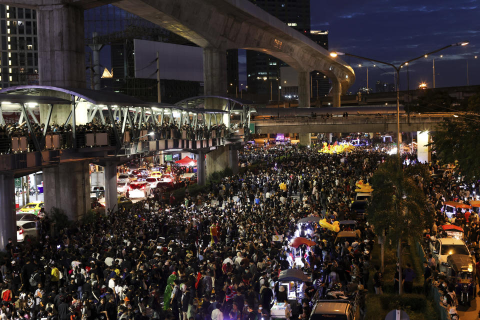 A crowd gathers during a rally Friday, Nov. 27, 2020 in Bangkok, Thailand. Pro-democracy demonstrators are continuing their protests calling for the government to step down and reforms to the constitution and the monarchy, despite legal charges being filed against them and the possibility of violence from their opponents or a military crackdown. (AP Photo/Wason Wanichakorn)