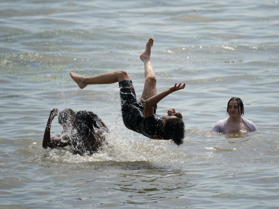 People play in the water at Southend-on-Sea on the Thames Estuary in Essex (Yui Mok/PA) (PA Wire)