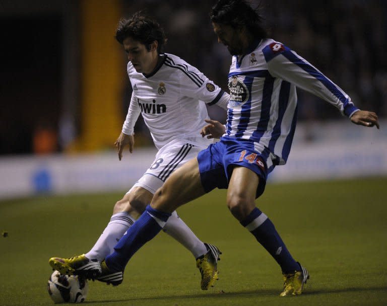 Real Madrid's midfielder Kaka (L) clashes with Deportivo's midfielder Abel Aguilar during the Spanish league football match at Riazor stadium in Coruna on February 23, 2013. Real Madrid had to come from behind as second-half goals from Kaka and Gonzalo Higuain handed them a hard-fought 2-1 at relegation threatened Deportivo La Coruna