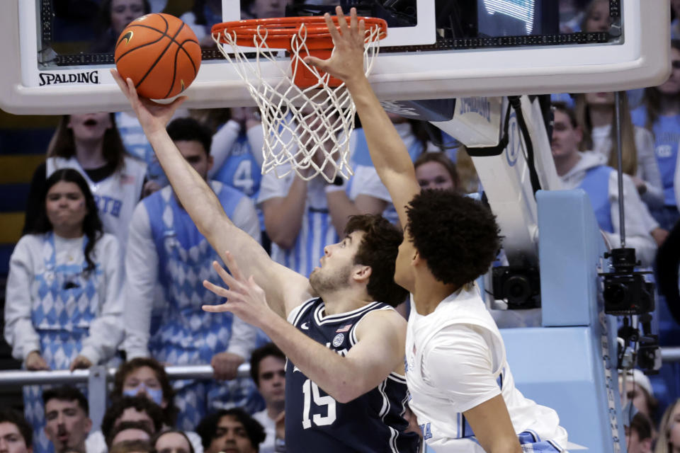 Duke center Ryan Young (15) drives to the basket against North Carolina guard Seth Trimble, right, during the first half of an NCAA college basketball game Saturday, Feb. 3, 2024, in Chapel Hill, N.C. (AP Photo/Chris Seward)