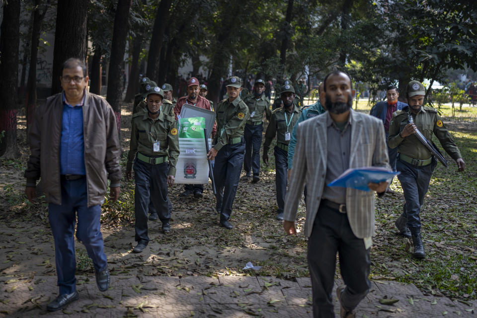 Security officers carry ballot boxes for distribution in Dhaka, Bangladesh, Saturday, Jan. 6, 2024. Bangladesh’s main opposition party has enforced a 48-hour general strike from Saturday across the South Asian nation as the nation is ready to hold its next general election a day later. (AP Photo/Altaf Qadri)