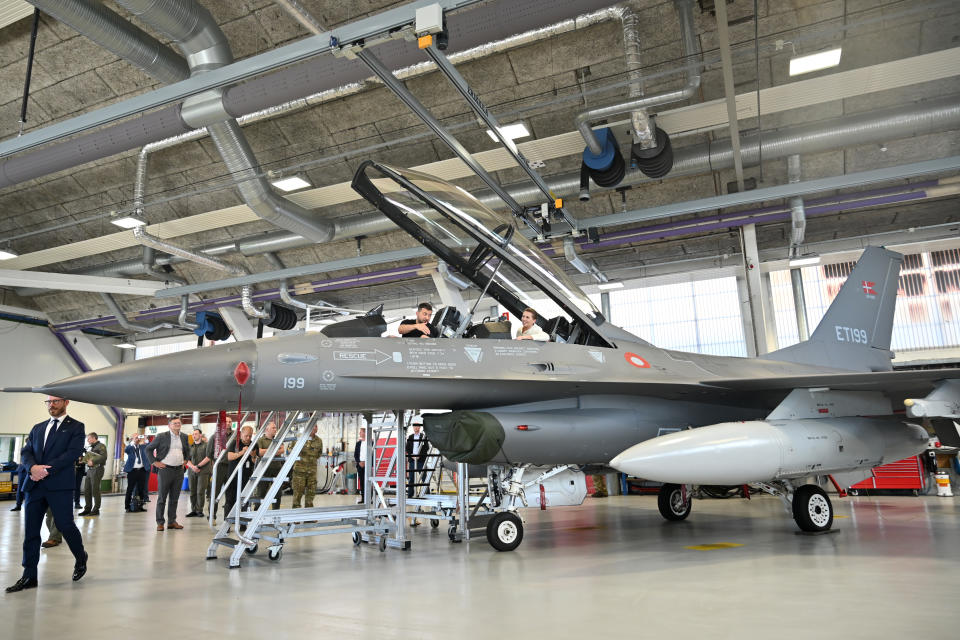 Der ukrainische Präsident Wolodymyr Selenskyj (l.) und die dänische Premierministerin Mette Frederiksen (r.) sitzen am 20. August 2023 in einem F-16-Kampfflugzeug im Hangar des Luftwaffenstützpunkts Skrydstrup in Vojens, Norddänemark. - Washington hat Dänemark und die Das US-Außenministerium teilte den Niederlanden am 18. August 2023 mit, dass sie ihre F-16-Kampfflugzeuge an die Ukraine übergeben dürfen, wenn die Piloten des Landes für deren Bedienung ausgebildet sind. Sowohl Dänemark als auch die Niederlande leiten das Programm zur Ausbildung ukrainischer Flugzeuge Piloten auf der F-16. (Foto von Sergei GAPON / AFP)