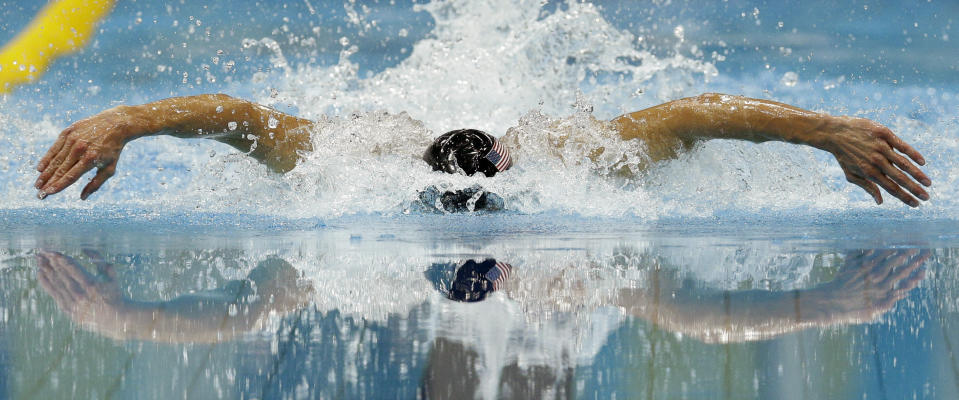 FILE - United States' Michael Phelps competes in the men's 100-meter butterfly swimming semifinal at the Aquatics Centre in the Olympic Park during the 2012 Summer Olympics in London, Aug. 2, 2012. Almost any Olympic athlete can tell you where the spark was lit to push them into sports. For many, it was in front of a TV set as a kid, watching the Summer Games play out in some faraway place — and often, Michael Phelps was the athlete that drew their interest. (AP Photo/Michael Sohn, File)