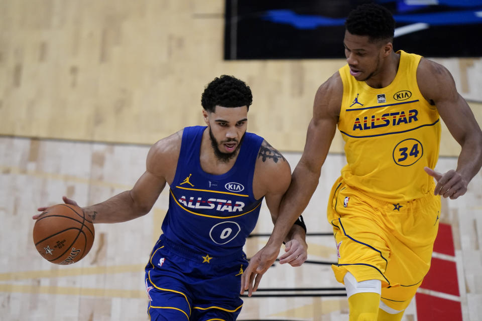 Boston Celtics Guard Jayson Tatum drives around Milwaukee Bucks forward Giannis Antetokounmpo during the first half of basketball's NBA All-Star Game in Atlanta, Sunday, March 7, 2021. (AP Photo/Brynn Anderson)