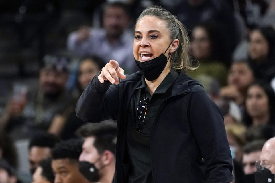 FILE- San Antonio Spurs assistant coach Becky Hammon directs players during the first half of an NBA basketball game against the Dallas Mavericks, on Nov. 12, 2021, in San Antonio. The WNBA will begin its 26th season this weekend with many fascinating storylines including the potential retirement of Sue Bird and Sylvia Fowles, the return of Becky Hammon as a coach and the absence of Brittney Griner. (AP Photo/Eric Gay, File)