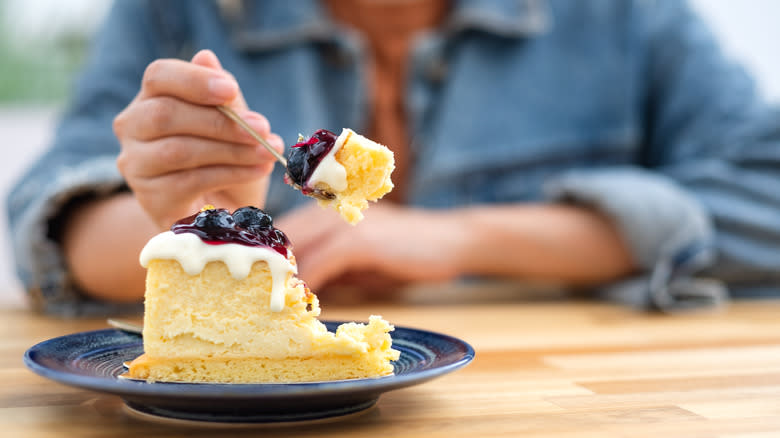 person eating cheesecake