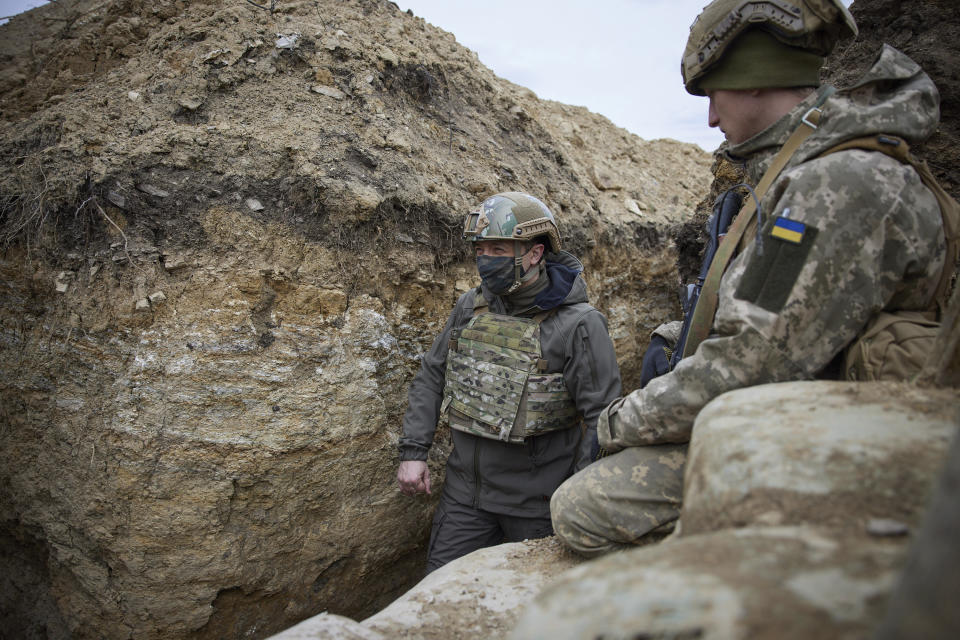 Ukrainian President Volodymyr Zelenskyy looks on as he visits the war-hit Donbas region, eastern Ukraine, Thursday, April 8, 2021. Ukraine's president is visiting the area of conflict in his country's east amid an escalation of tensions that has raised fears of a resumption of large-scale hostilities. (Ukrainian Presidential Press Office via AP)