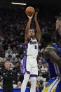 Sacramento Kings forward Keegan Murray, center, shoots a 3-point basket during the first half of an NBA basketball play-in tournament game against the Golden State Warriors, Tuesday, April 16, 2024, in Sacramento, Calif. (AP Photo/Godofredo A. Vásquez)