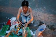 Street vendor Yan Ying sells tea at a her improvised stall following an outbreak of the coronavirus disease (COVID-19) in Beijing