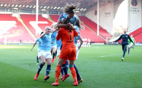 janine Beckie of Manchester City Women celebrates with teammate Karen Bardsley after scoring the winning penalty during the FA Women's Continental League Cup Final between Arsenal and Manchester City Women at Bramall Lane - Credit: Getty images