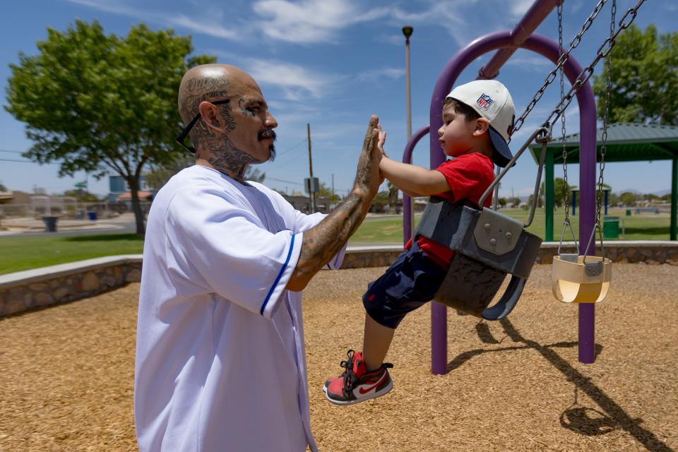 El Paso Chicano rap artist Fabian Primera 'Payaso915' plays with his grandson Jacob Jeremiah Rivero at Pueblo Viejo Park  on Thursday, July 20, 2023, in Ysleta.