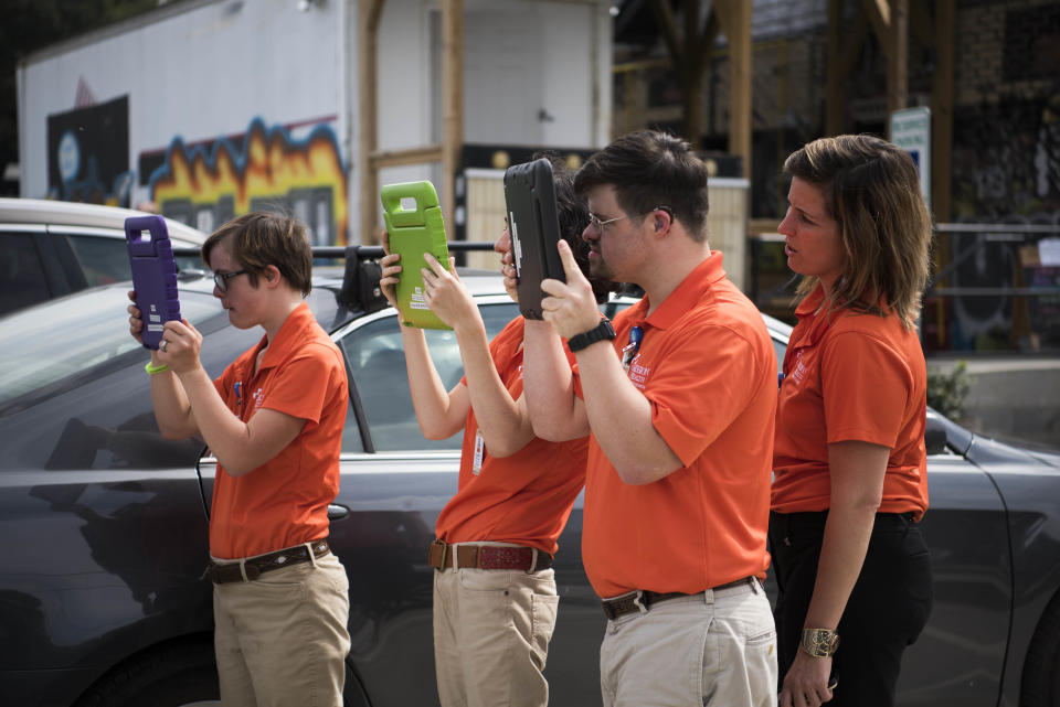 Interns from Mission Health take photos of the HuffPost bus.