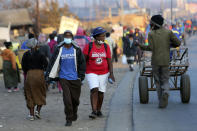 People wear face masks to protect against coronavirus in Harare, Monday, Sept. 21, 2020. As Zimbabwe's coronavirus infections decline, strict lockdowns designed to curb the disease are being replaced by a return to relatively normal life. The threat has eased so much that many people see no need to be cautious, which has invited complacency. (AP Photo/Tsvangirayi Mukwazhi)