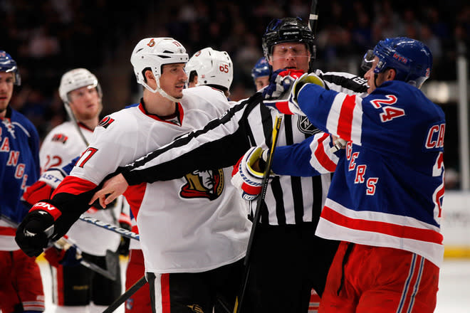 NEW YORK, NY - APRIL 21: linesman Scott Driscoll #68 breaks up a fight against Filip Kuba #17 of the Ottawa Senators and Ryan Callahan #24 of the New York Rangers in Game Five of the Eastern Conference Quarterfinals during the 2012 NHL Stanley Cup Playoffs at Madison Square Garden on April 21, 2012 in New York City. (Photo by Mike Stobe/Getty Images)