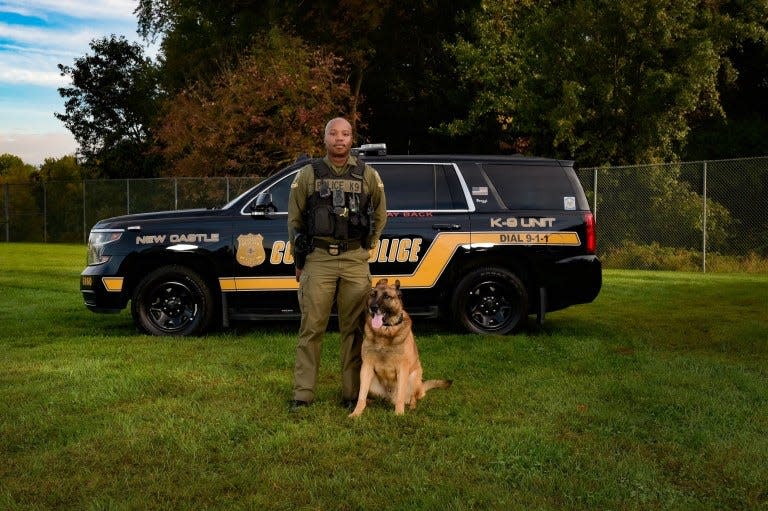 New Castle County Police Department Master Cpl. Richard Blackston stands next to his K-9 partner, Prezzi. The dog died in 2021.