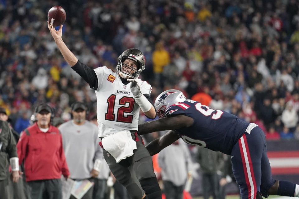 Tampa Bay Buccaneers quarterback Tom Brady (12) throws while pressured by New England Patriots defensive tackle Christian Barmore (90) during the second half of an NFL football game, Sunday, Oct. 3, 2021, in Foxborough, Mass. (AP Photo/Steven Senne)