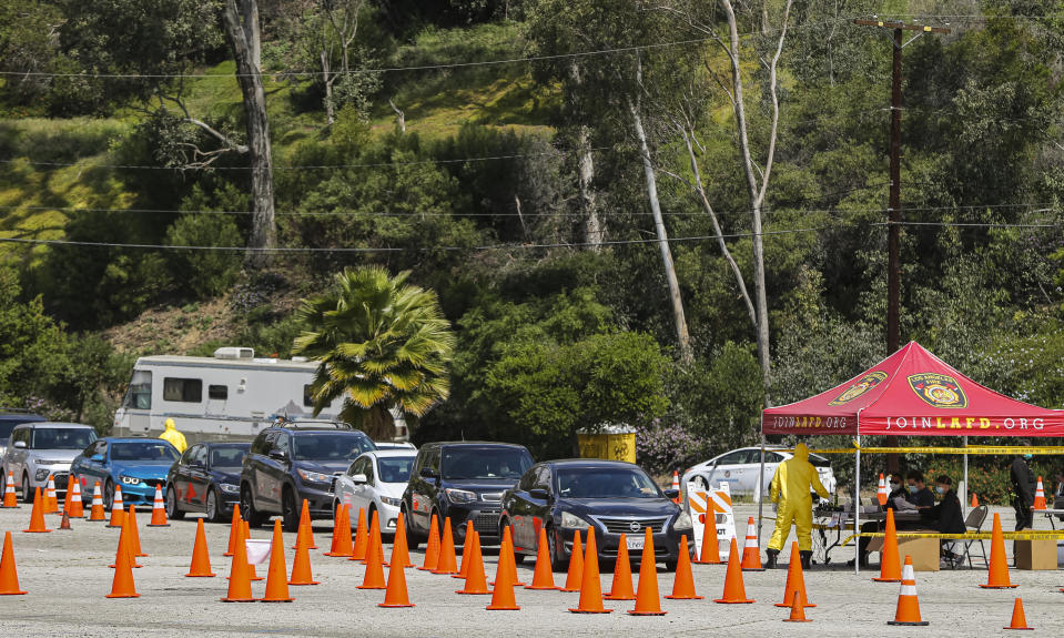 Long lines await for people who were scheduled to be tested for COVID-19 at a drive-up testing site in Elysian Park, Thursday, April 2, 2020. Officials say hand-washing and keeping a safe social distance are priorities in battling the COVID-19 virus. (AP Photo/Damian Dovarganes)