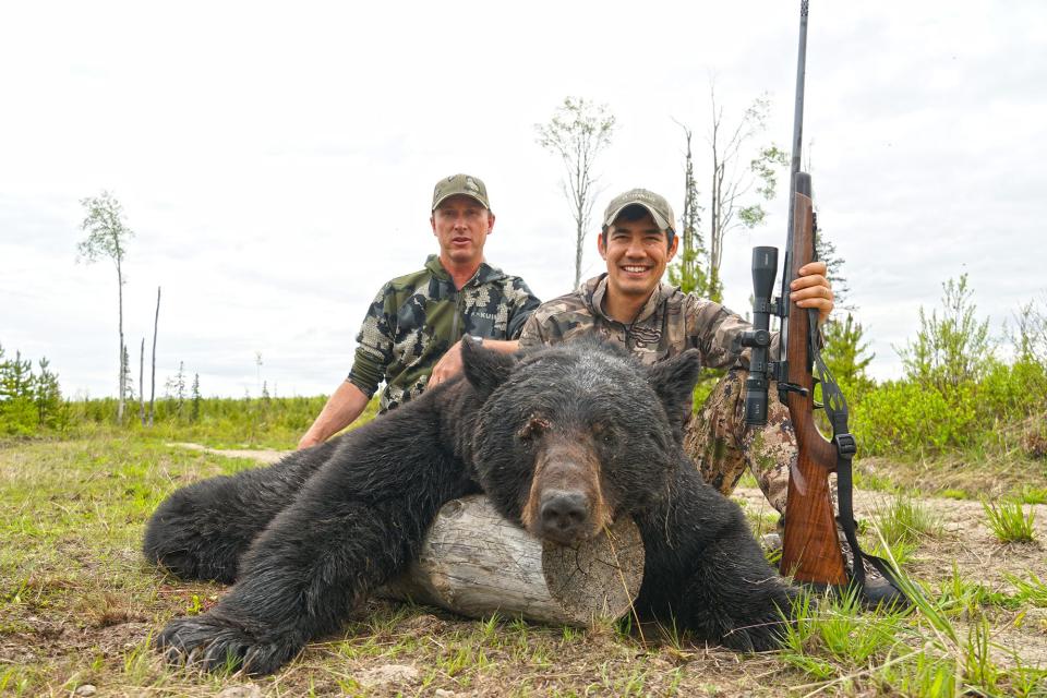 Bettcher and the author with a stud boar black bear.