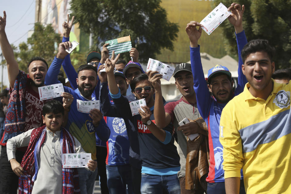 Pakistani cricket fans show their tickets as they arrive at the National Stadium to watch Pakistani Super League match between Karachi Kings and Peshawar Zalmi in Karachi, Pakistan, Friday, Feb. 21, 2020. (AP Photo/Fareed Khan)