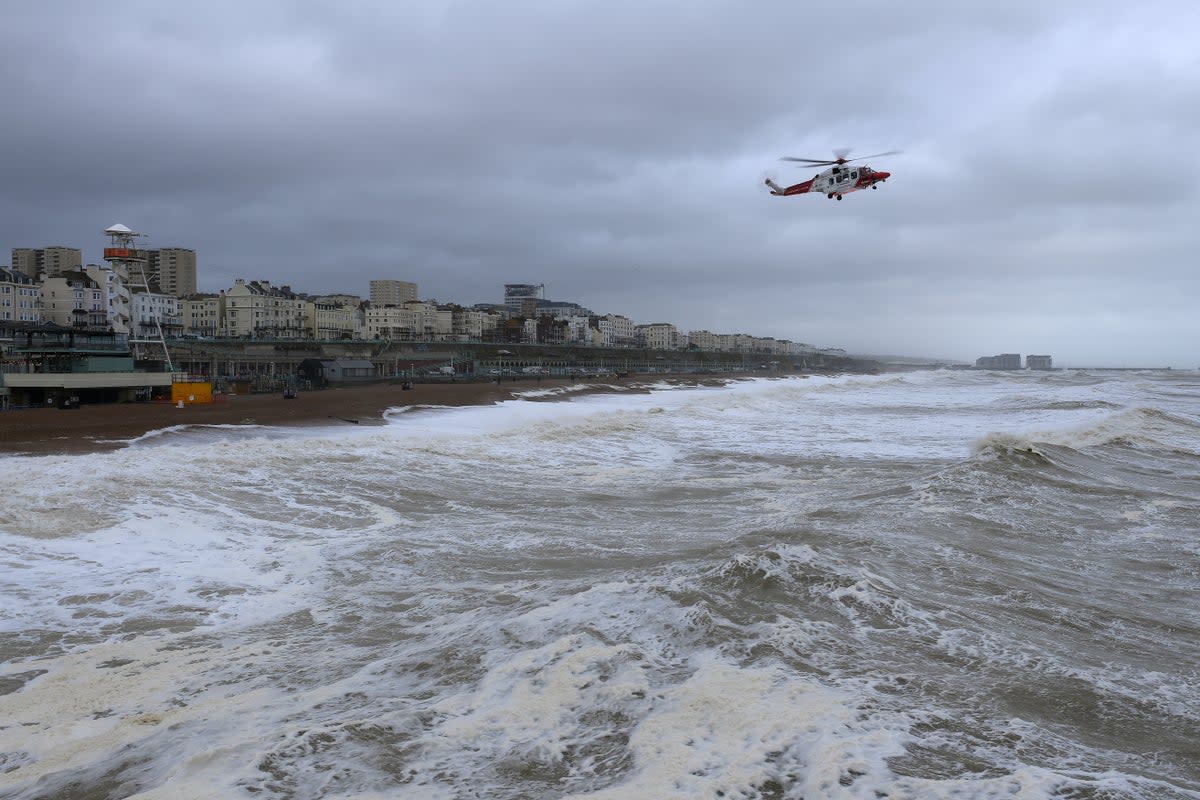 A coastguard helicopter scours the rough sea off the Brighton coast on Wednesday (Mike Hewitt/Getty Images)