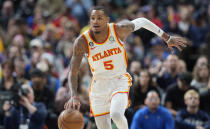 Atlanta Hawks guard Dejounte Murray picks up a loose ball in the first half of an NBA basketball game against the Denver Nuggets Saturday, Feb. 4, 2023, in Denver. (AP Photo/David Zalubowski)