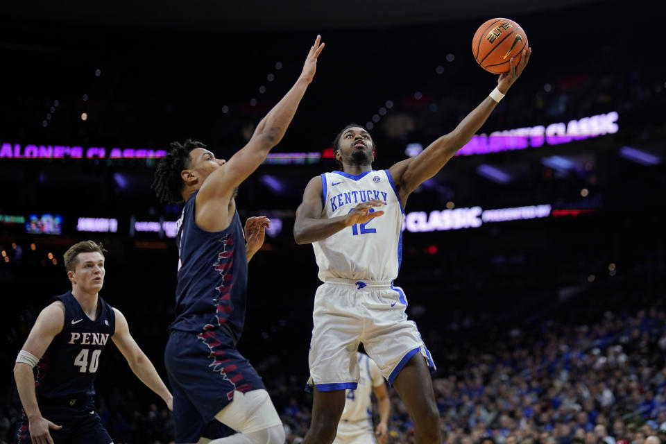 Kentucky's Antonio Reeves, right, goes up for a shot past Pennsylvania's Tyler Perkins during the second half of an NCAA college basketball game, Saturday, Dec. 9, 2023, in Philadelphia. (AP Photo/Matt Slocum)