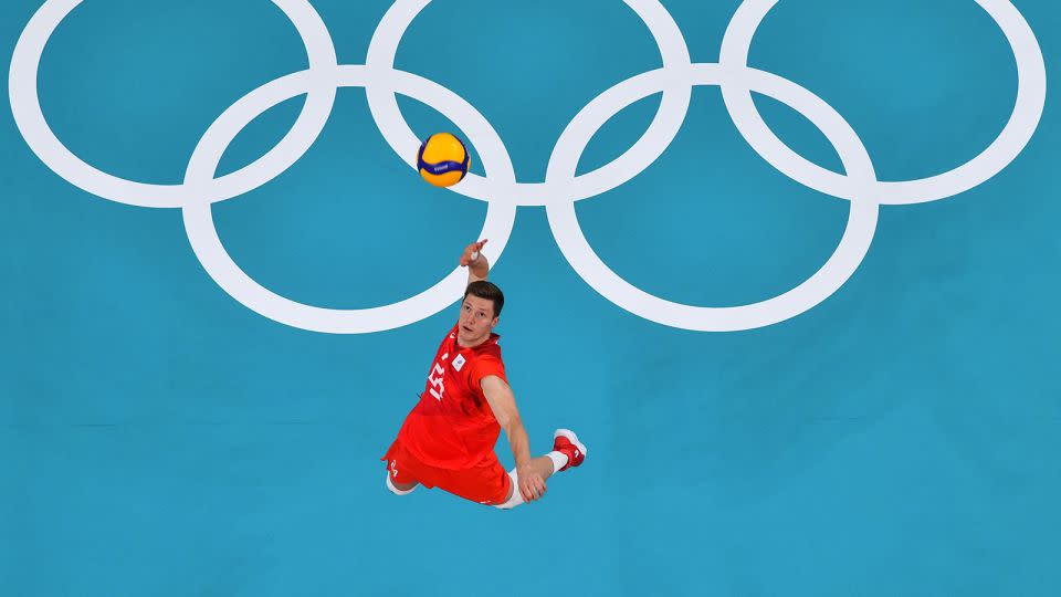Russia's Igor Kobzar serves in the men's gold medal volleyball match between France and Russia during the Tokyo 2020 Olympics – there will be no Russian representation in team events this year. - Antonin Thuillier/AFP/Getty Images