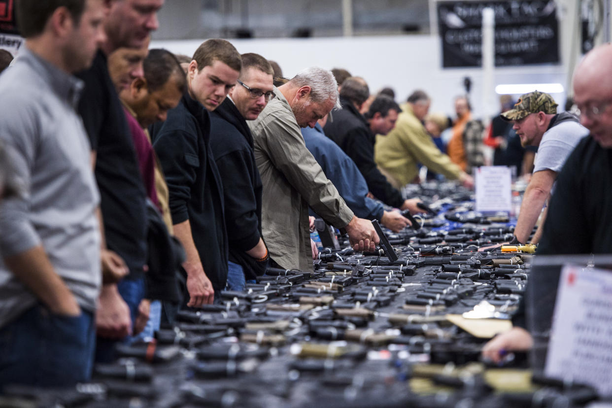 People look at handguns during The Nation's Gun Show in Chantilly, Va. on October 3, 2015. (Jabin Botsford / The Washington Post via Getty Images file)