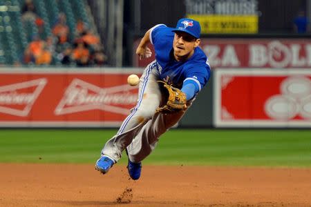 Sep 30, 2015; Baltimore, MD, USA; Toronto Blue Jays shortstop Darwin Barney (18) throws to first base for the force out of Baltimore Orioles right fielder Ryan Flaherty (not pictured) during the seventh inning at Oriole Park at Camden Yards. Toronto Blue Jays defeated Baltimore Orioles 15-2 and clinched the A.L. East division Tommy Gilligan-USA TODAY Sports