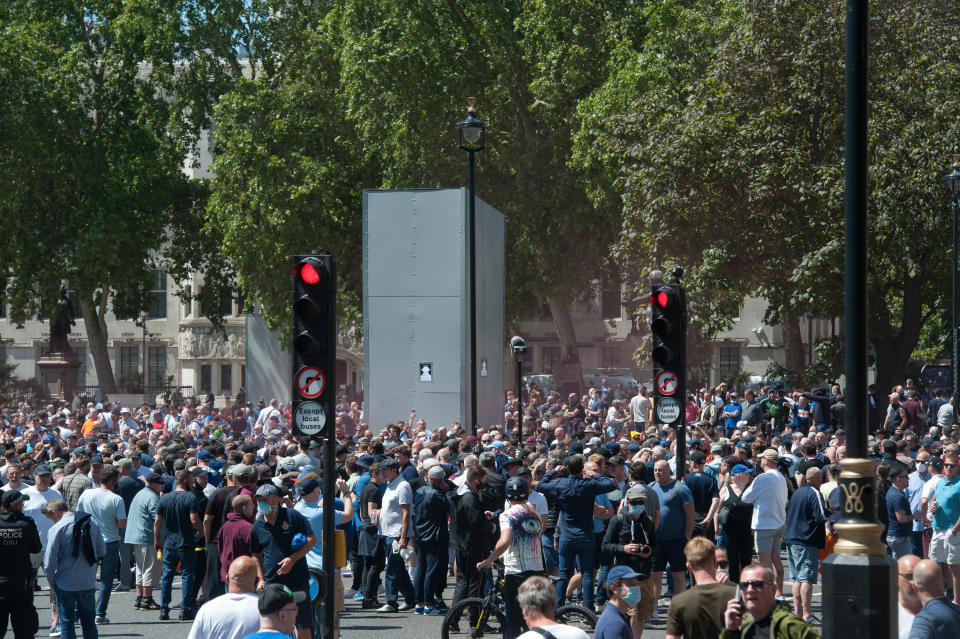 LONDON, ENGLAND - JUNE 13: DFLA and other protest groups gather at the boarded up Churchill statue in Parliament square on June 13, 2020 in London, England. A number of anti-racism protesters have gathered for demonstrations in the UK despite the cancellation of the official events due to fears of clashes with far-right agitating groups. Following a social media post by the far-right activist known as Tommy Robinson, members of far-right linked groups have gathered around statues in London, which have been targeted by Black Lives Matter protesters for their links to racism and the slave trade. (Photo by Guy Smallman/Getty Images)