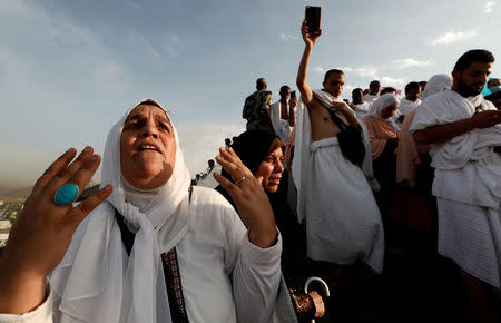 A Muslim pilgrim prays as she gather with others on Mount Mercy on the plains of Arafat during the annual haj pilgrimage, outside the holy city of Mecca, Saudi Arabia August 20, 2018. REUTERS/Zohra Bensemra