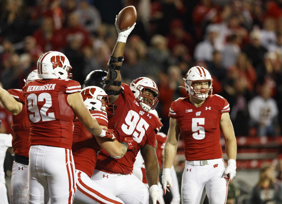 Oct 16, 2021; Madison, Wisconsin, USA; Wisconsin Badgers nose tackle Keeanu Benton (95) celebrates after recovering a fumble against the Army Black Knights during the fourth quarter at Camp Randall Stadium. Mandatory Credit: Jeff Hanisch-USA TODAY Sports