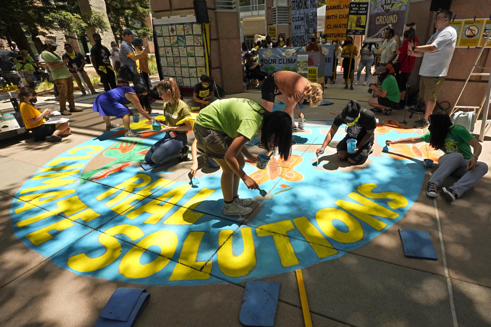 FILE - People calling for a climate solution demonstrate outside of a hearing of the California Air Resources Board in Sacramento, Calif., June 23, 2022. (AP Photo/Rich Pedroncelli, File)