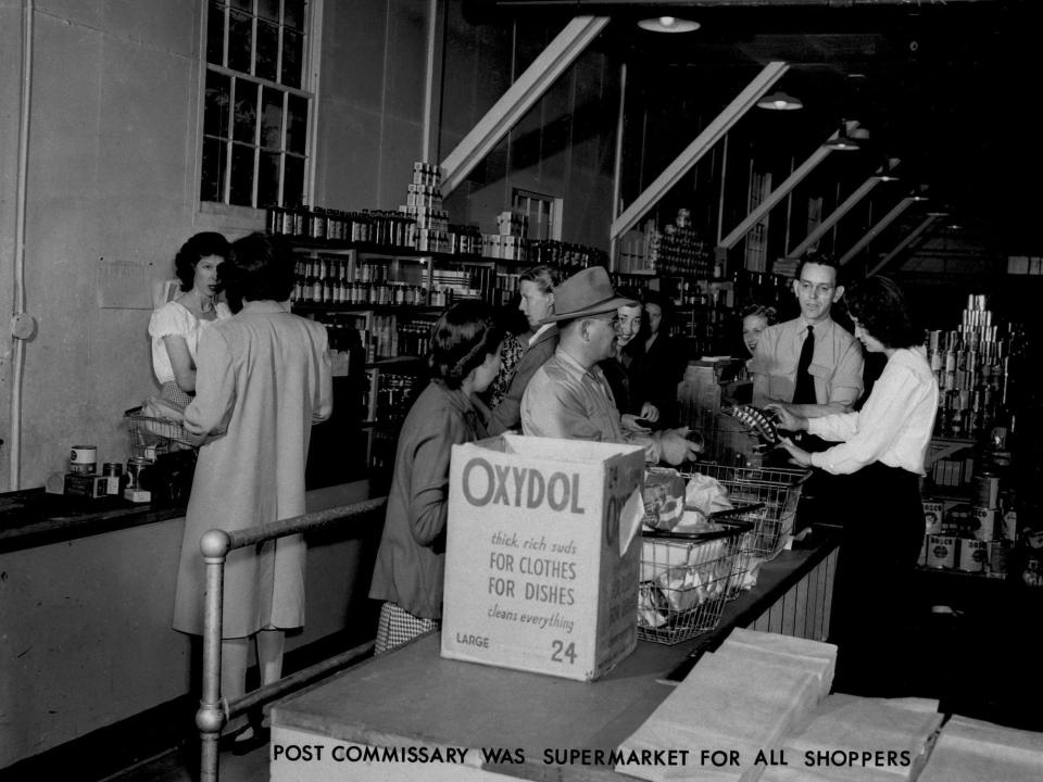 Several people shop at the Los Alamos commissary circa 1945