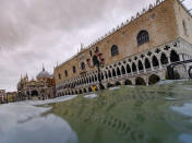 Water rises in Venice, Italy, Sunday, Nov. 17, 2019. Venetians are bracing for the prospect of another exceptional tide in a season that is setting new records. Officials are forecasting a 1.6 meter (5 feet, 2 inches) surge Sunday. That comes after Tuesday's 1.87 meter flood, the worst in 53 years, followed by high tide of 1.54 meters on Friday. (AP Photo/Luca Bruno)