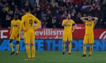 Soccer Football - Spanish King's Cup - Quarter Final Second Leg - Sevilla vs Atletico Madrid - Ramon Sanchez Pizjuan, Seville, Spain - January 23, 2018 Atletico Madrid's Diego Godin and team mates react after conceding their third goal REUTERS/Jon Nazca