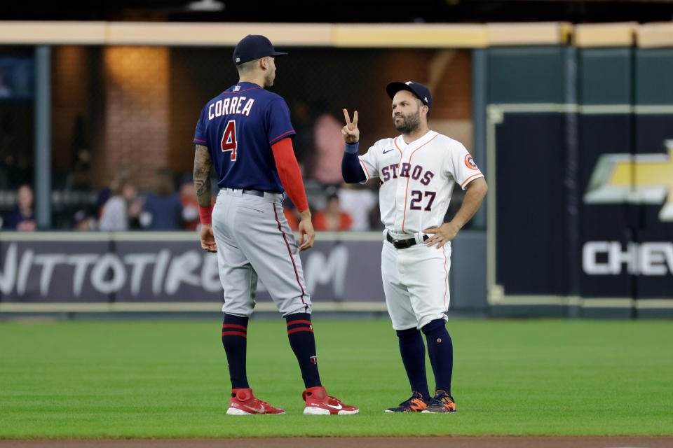 HOUSTON, TEXAS - AUGUST 25: Jose Altuve #27 of the Houston Astros talks with Carlos Correa #4 of the Minnesota Twins prior to the game at Minute Maid Park on August 25, 2022 in Houston, Texas. (Photo by Tim Warner/Getty Images)