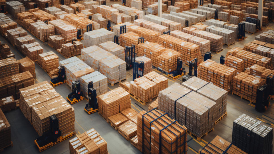 Aerial view of a large warehouse loaded with pallets and crates of food products.