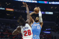 Los Angeles Clippers forward Paul George (13) shoots against Detroit Pistons forward Isaiah Stewart (28) during the second half of an NBA basketball game, Friday, Nov. 26, 2021, in Los Angeles. (AP Photo/Ringo H.W. Chiu)