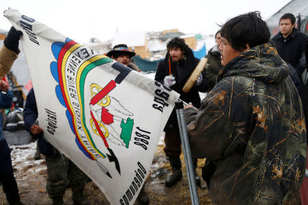 Oscar High Elk, 26, of the Cheyenne River Sioux Tribe, prays as he and other members of the tribe prepare to evacuate from the main opposition camp against the Dakota Access oil pipeline near Cannon Ball, North Dakota, U.S., February 22, 2017. REUTERS/Terray Sylvester