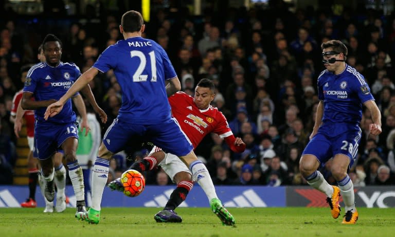 Manchester United's midfielder Jesse Lingard (C) shoots and scores past Chelsea's midfielder Nemanja Matic (2ndL) during an English Premier League football match at Stamford Bridge in London on February 7, 2016