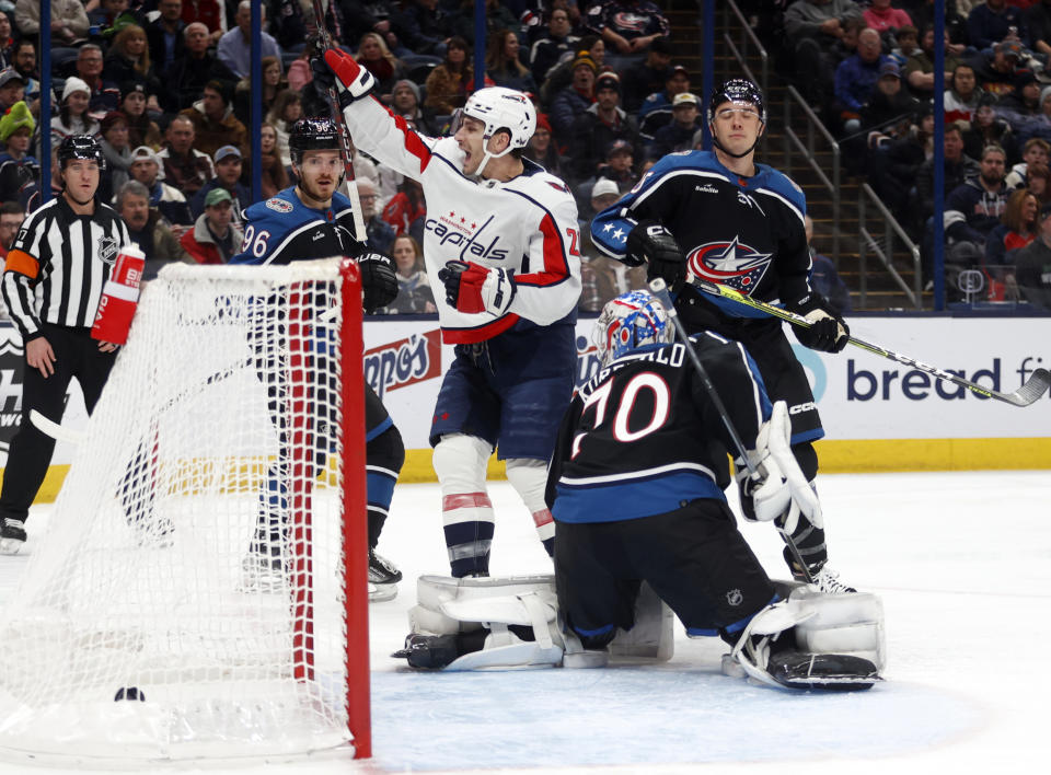 Washington Capitals forward Garnet Hathaway (21) celebrates his goal between Columbus Blue Jackets forward Jack Roslovic (96), goalie Joonas Korpisalo (70) and defenseman Gavin Bayreuther (15) during the first period of an NHL hockey game in Columbus, Ohio, Tuesday, Jan. 31, 2023. (AP Photo/Paul Vernon)