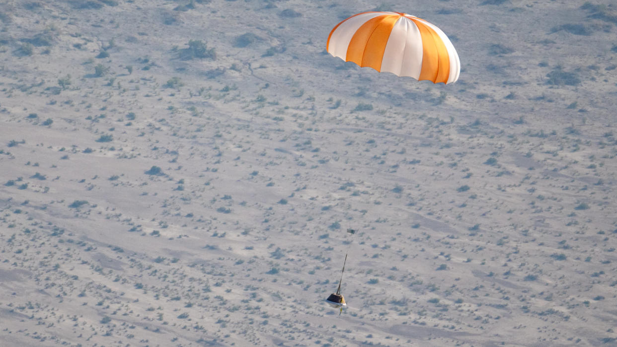  A sample space capsule parachuting to Earth in a test. 